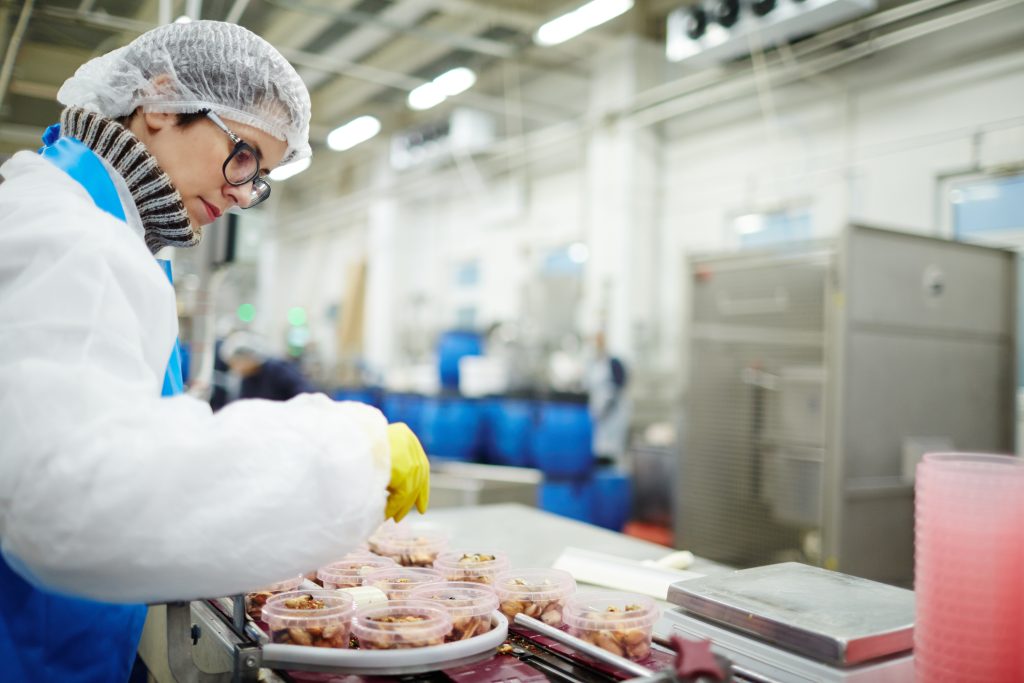 Staff sorting seafood into plastic containers